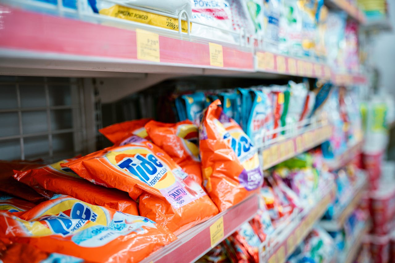 gallery-2 Vibrant selection of laundry detergents on a supermarket shelf, showcasing brands and variety.