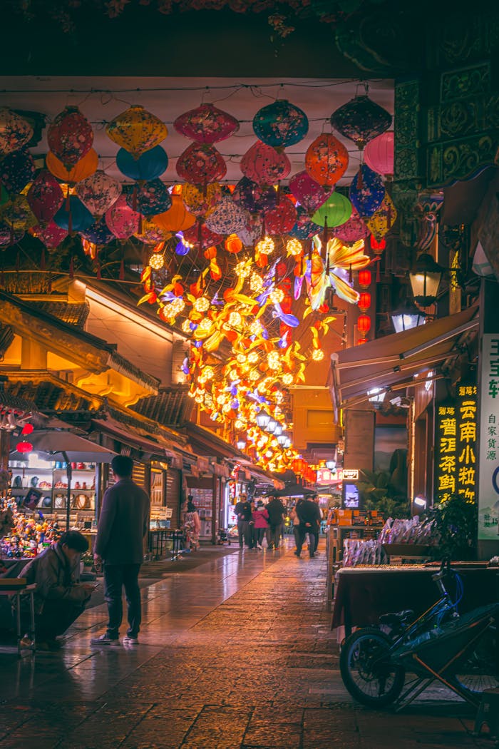 about-01 A vibrant display of traditional lanterns illuminates a bustling street market in Chongqing at night.